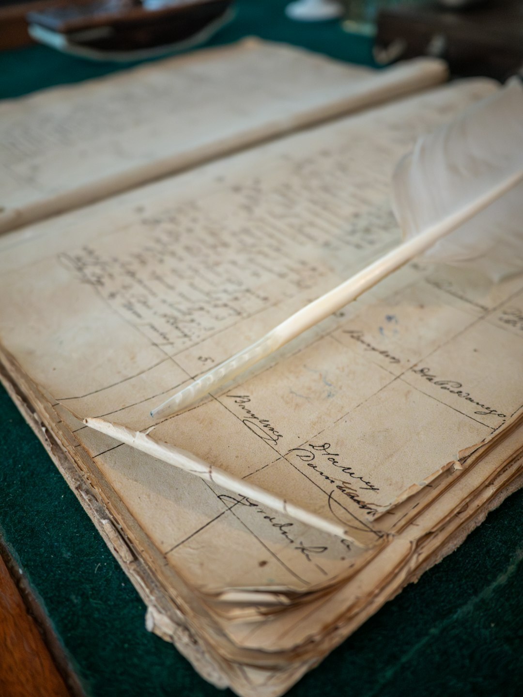 Open manuscript pages covered in handwritten notes next to a fountain pen