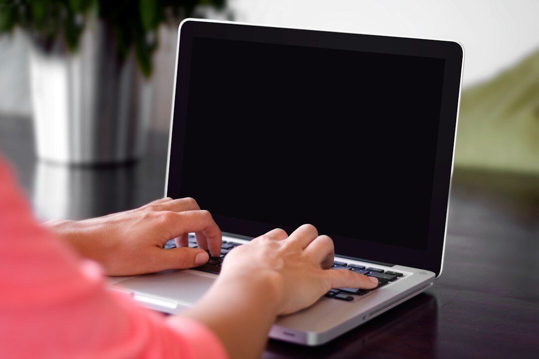 writer typing on laptop